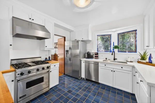 a kitchen with a stove a sink and a refrigerator