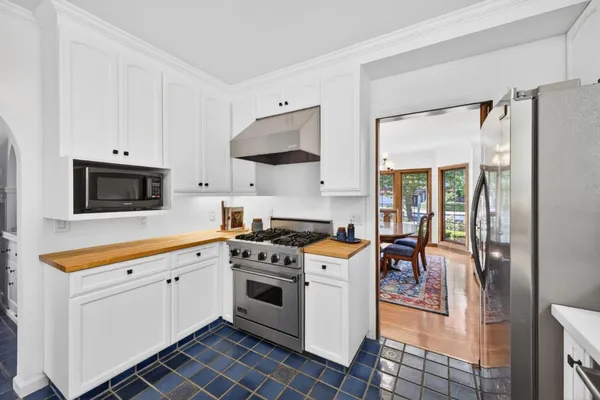 a kitchen with stainless steel appliances a stove a sink and a refrigerator