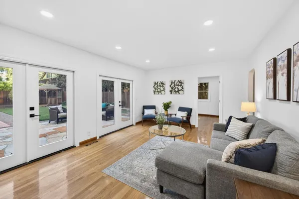 a living room with furniture and wooden floor