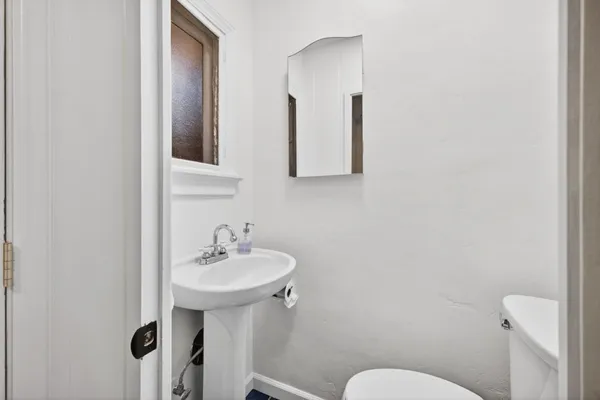 a bedroom with a bed and a potted plant