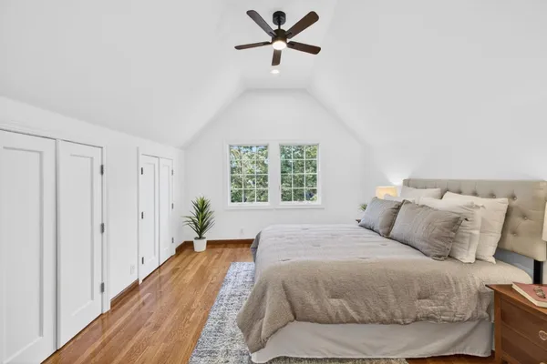 a bedroom with a bed and wooden floor