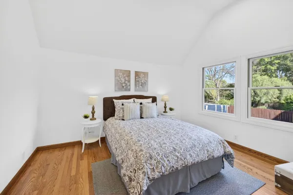 a bed sitting in a bedroom next to a window