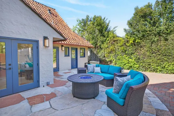 a front view of a house with yard green space and lake view