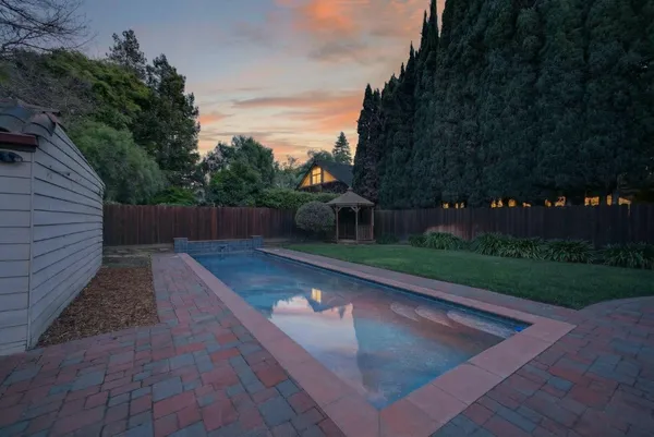 a view of a house with a yard and deck