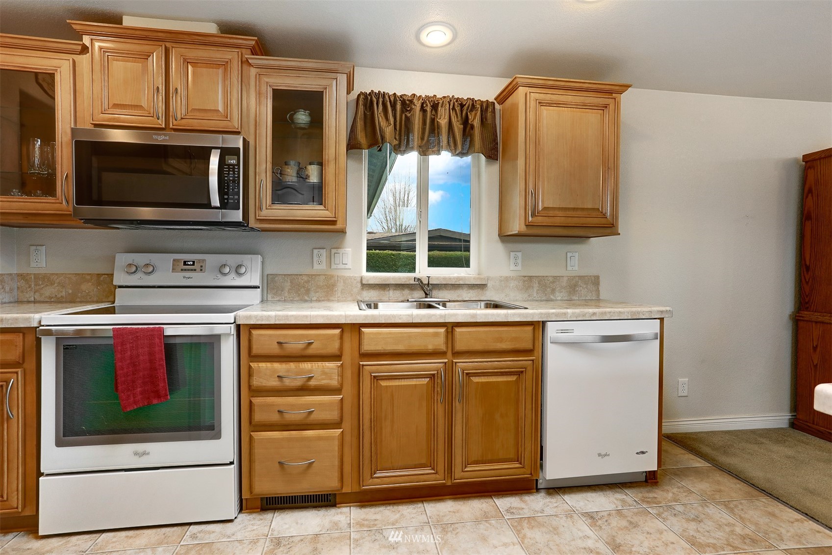 23910 Rock Circle Bothell, WA 98021 - Photo 6 of 40 a kitchen with stainless steel appliances granite countertop a stove microwave and cabinets