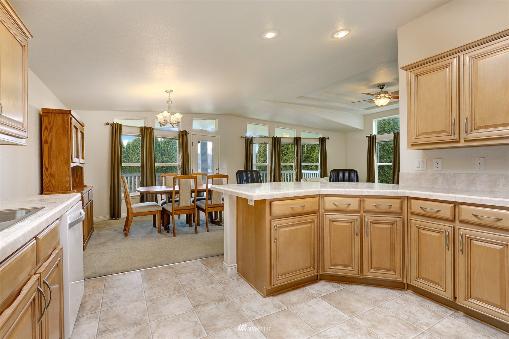 23910 Rock Circle Bothell, WA 98021 - Photo 8 of 40 a large white kitchen with lots of counter space and chandelier