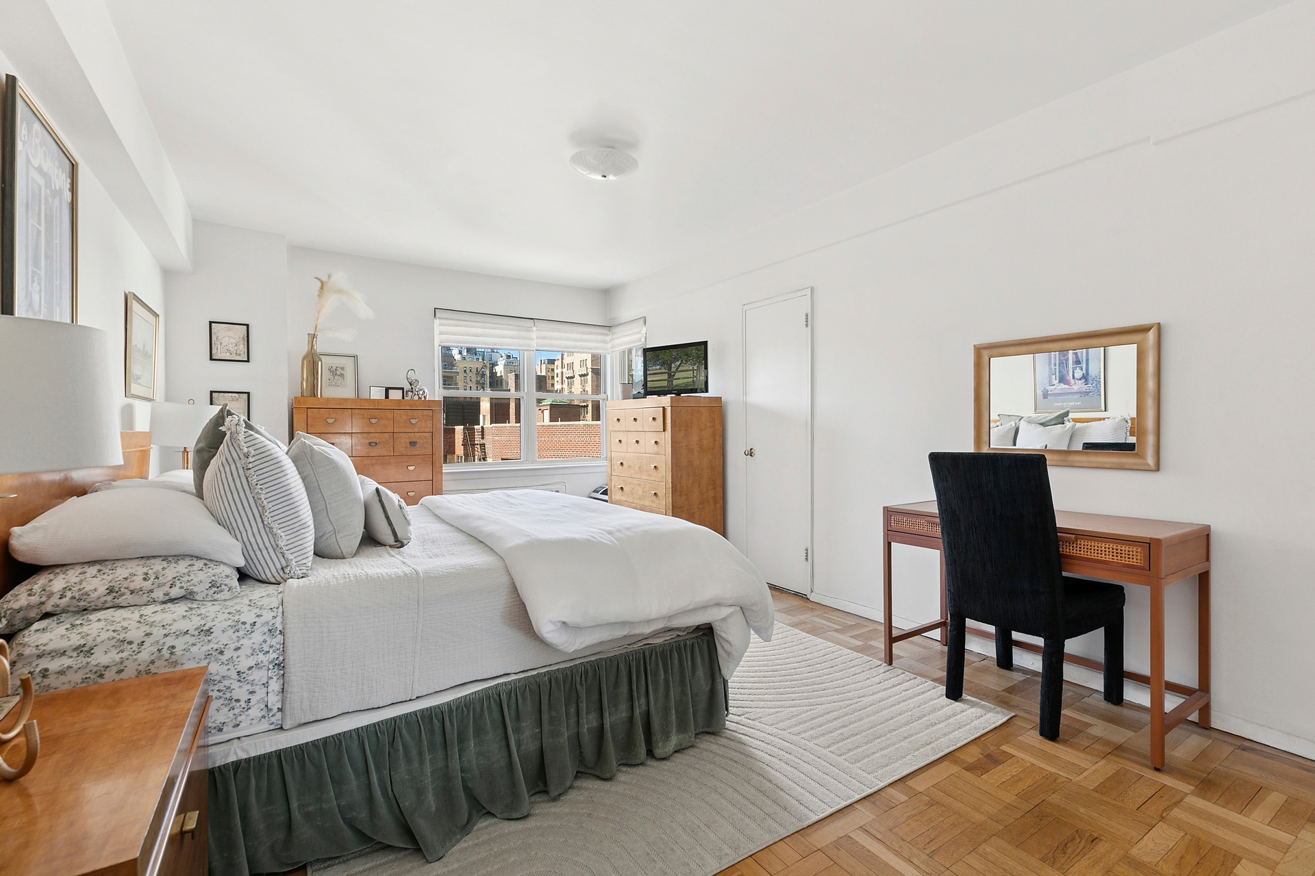 40 East 9th Street, Unit 7D Manhattan, NY 10003 - Photo 2 of 14 a bedroom with a bed and a table in it