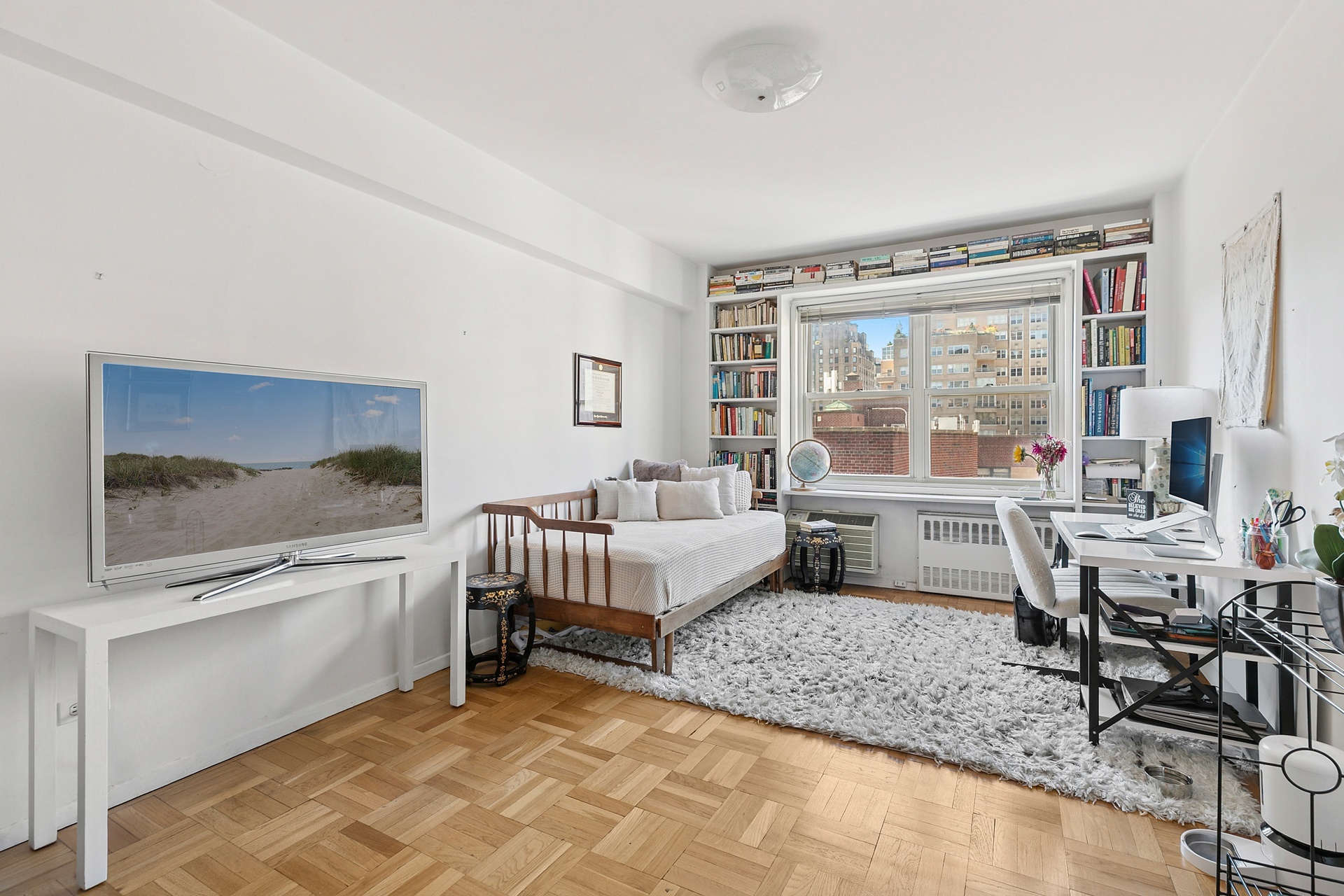 40 East 9th Street, Unit 7D Manhattan, NY 10003 - Photo 4 of 14 a living room with furniture and a flat screen tv
