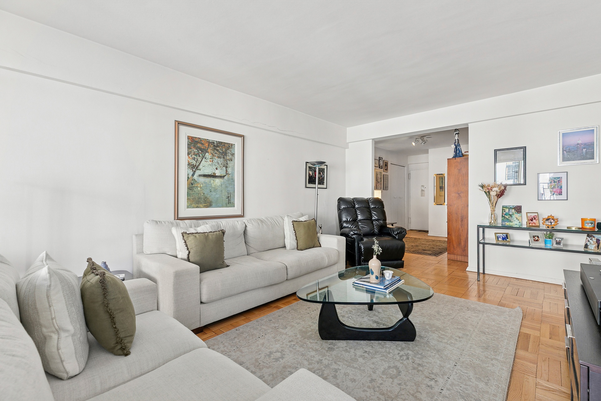 40 East 9th Street, Unit 7D Manhattan, NY 10003 - Photo 6 of 14 a living room with furniture and view of kitchen