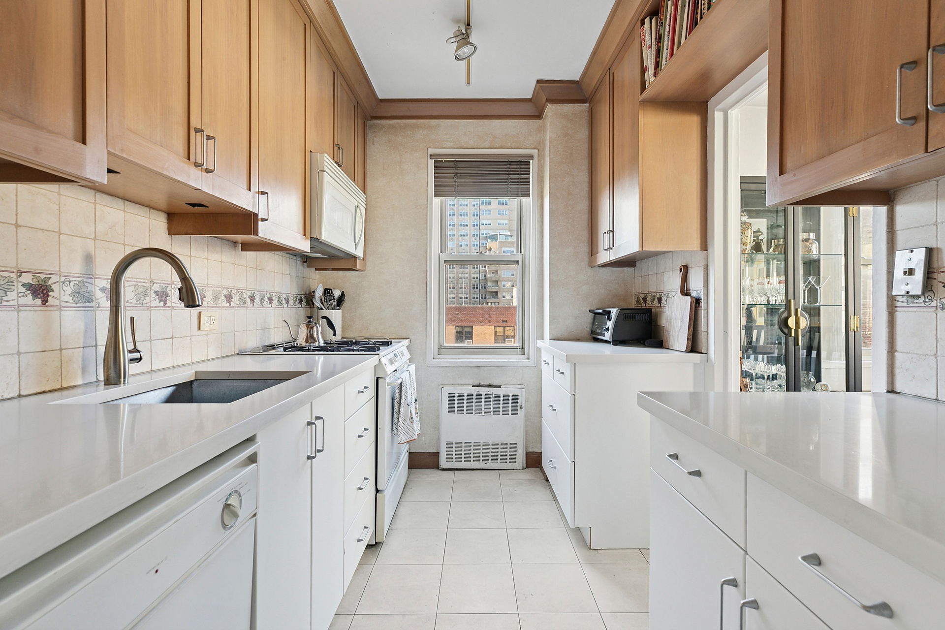 40 East 9th Street, Unit 7D Manhattan, NY 10003 - Photo 7 of 14 a kitchen with stainless steel appliances granite countertop a sink and cabinets