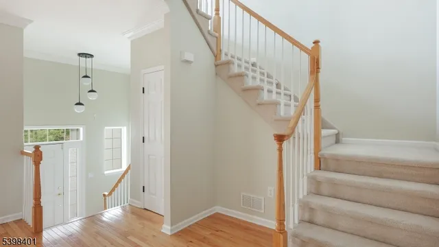 a view of entryway with wooden floor and a front door