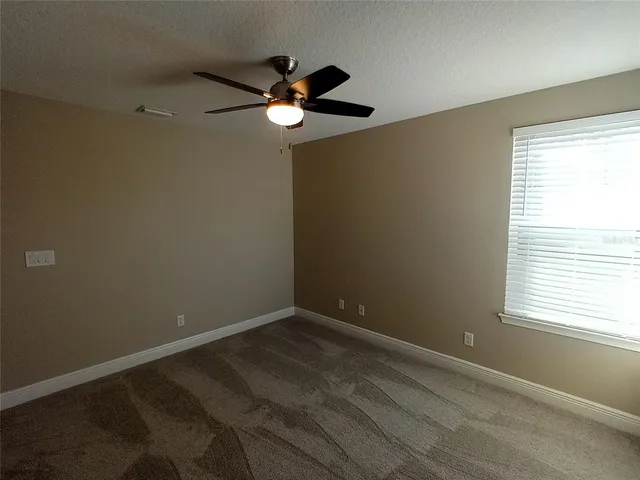 a view of room with window and ceiling fan