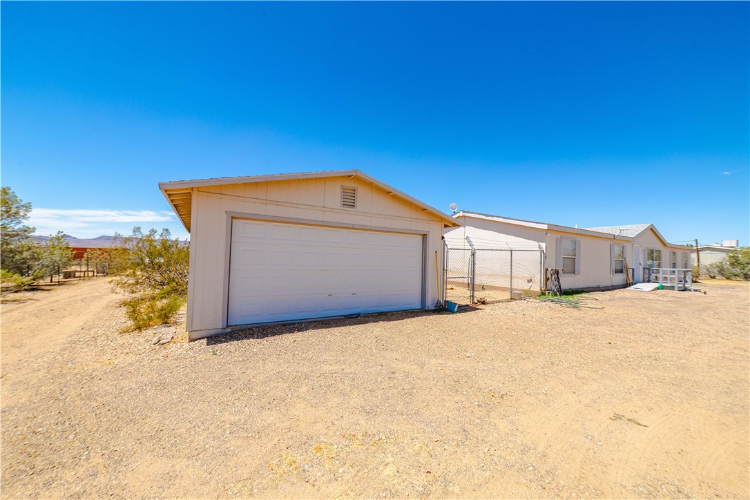 4729 Stewart Mountain Road Golden Valley, AZ 86413 - Photo 25 of 28 a view of a house with a snow in the yard