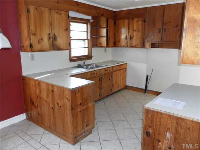 136 Cavel Chub Lake Road Roxboro, NC 27574 - Photo 5 of 11 a kitchen with stainless steel appliances granite countertop a sink and a stove