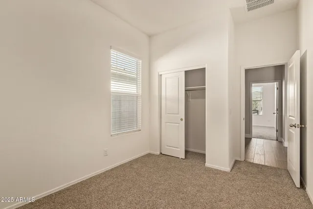 a bathroom with a granite countertop toilet a sink and a mirror