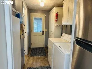 a kitchen with a table chairs cabinets and appliances