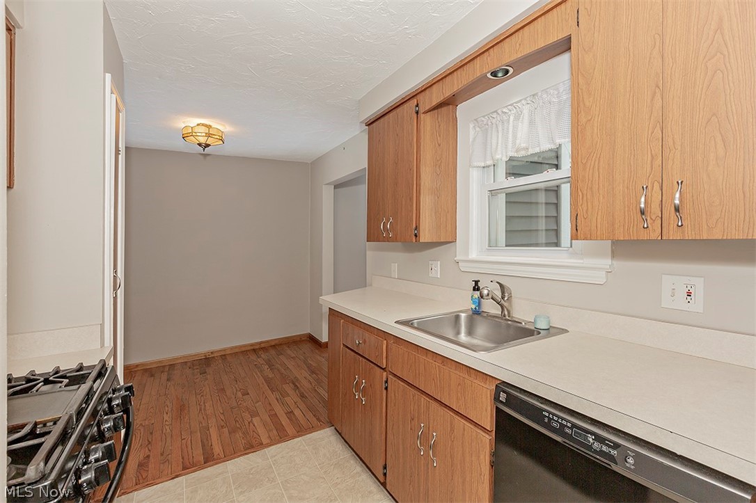5523 Huron Road Lyndhurst, OH 44124 - Photo 11 of 34 Gas range, dishwasher and refrigerator remain in the kitchen.