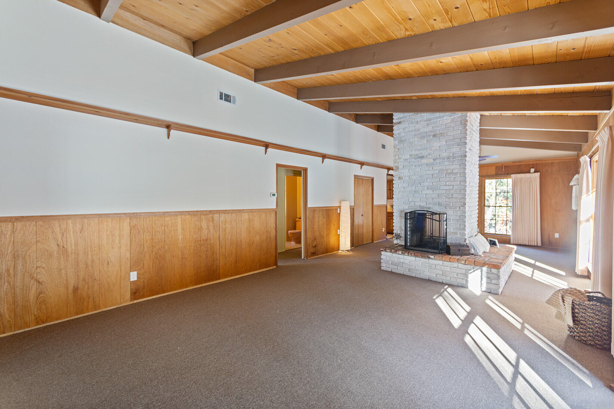 25465 Seneca Road Idyllwild, CA 92549 - Photo 11 of 38 a view of an empty room with fireplace and a window