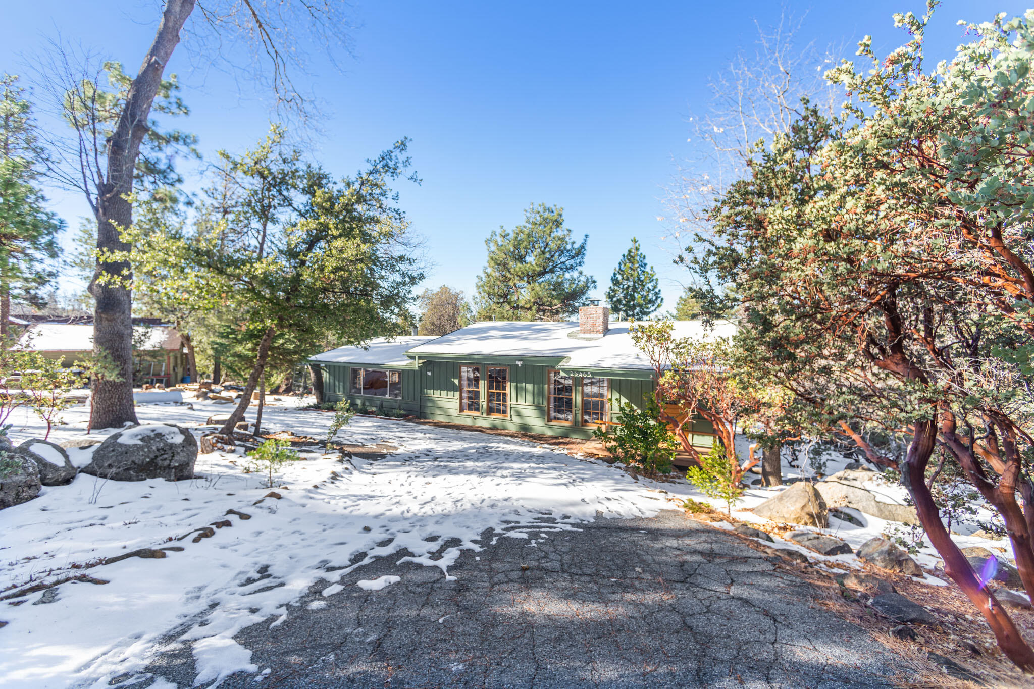 25465 Seneca Road Idyllwild, CA 92549 - Photo 2 of 38 a view of a white house with a large tree