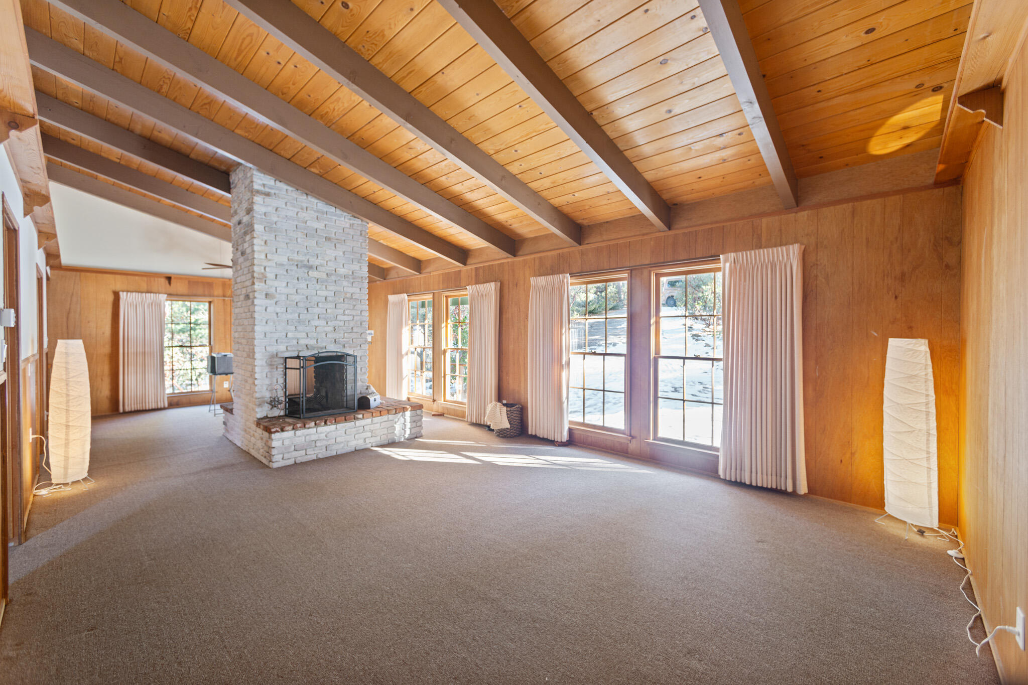 25465 Seneca Road Idyllwild, CA 92549 - Photo 9 of 38 a view of an empty room with a fireplace and a window