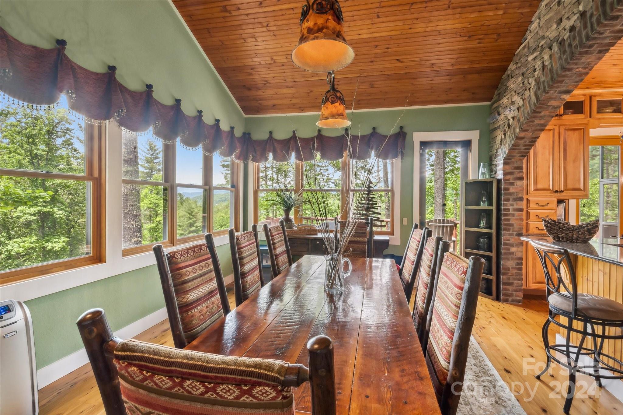 39 Elms Rest Cullowhee, NC 28723 - Photo 11 of 45 a dining room with furniture a chandelier and wooden floor