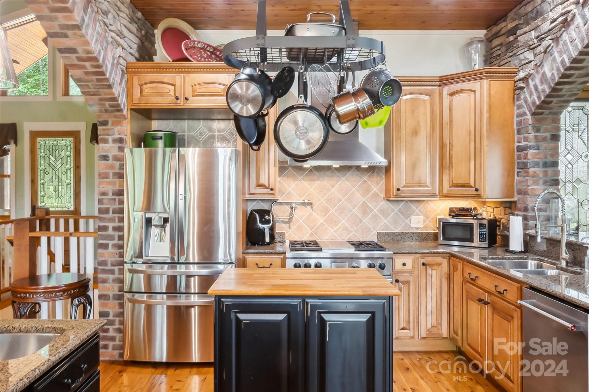 39 Elms Rest Cullowhee, NC 28723 - Photo 8 of 45 a kitchen with stainless steel appliances granite countertop a sink a stove and a wooden cabinets