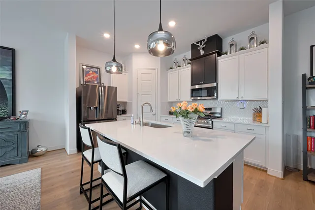 a kitchen with a table chairs and a refrigerator