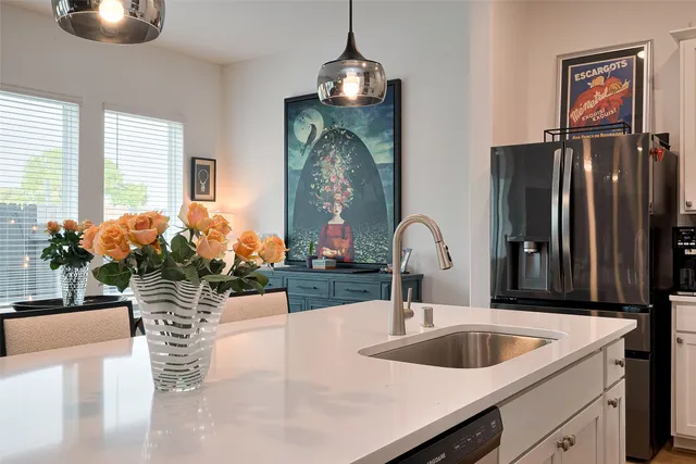 a kitchen with a refrigerator and a sink