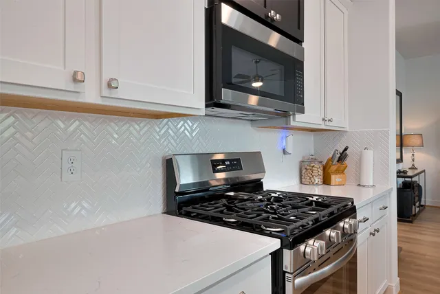 a kitchen with a stove and a microwave