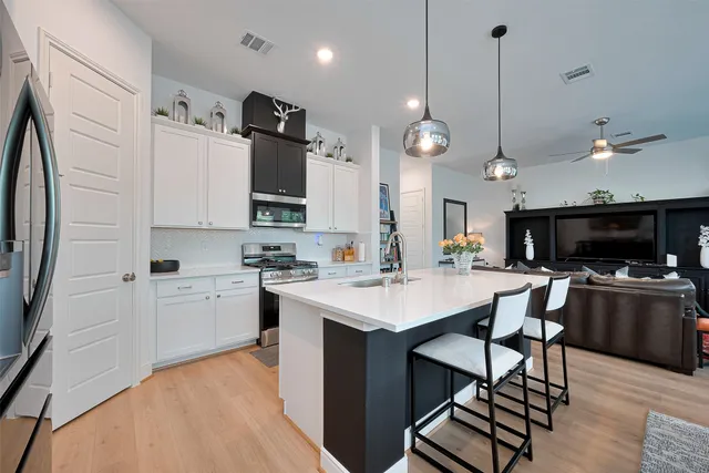 a large kitchen with stainless steel appliances kitchen island a large island in the center