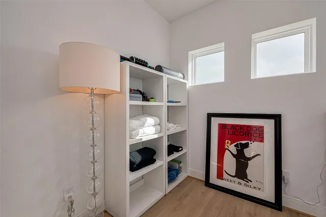 a view of a livingroom with wooden floor and a ceiling fan