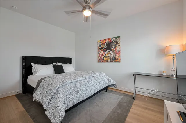 a bedroom with a large bed and a chandelier