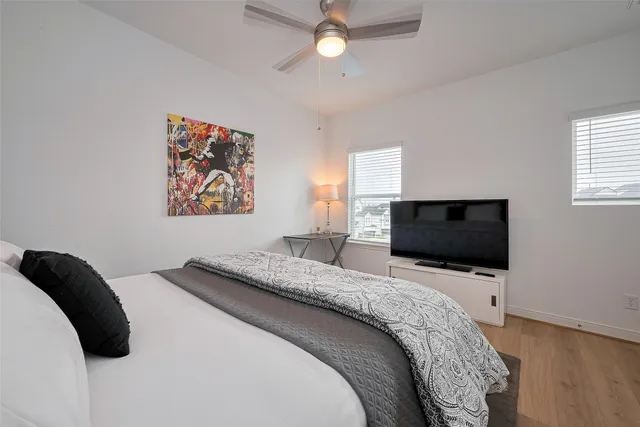 a bedroom with a bed and a flat screen tv