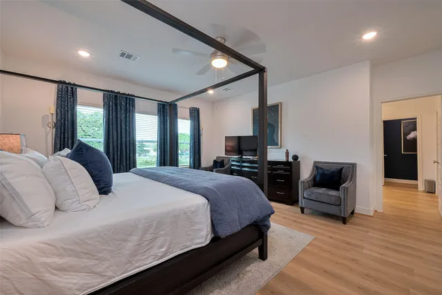 a bedroom with a bed and wooden floor