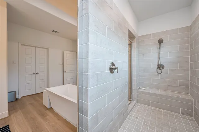 a bathroom with a bathtub and shower