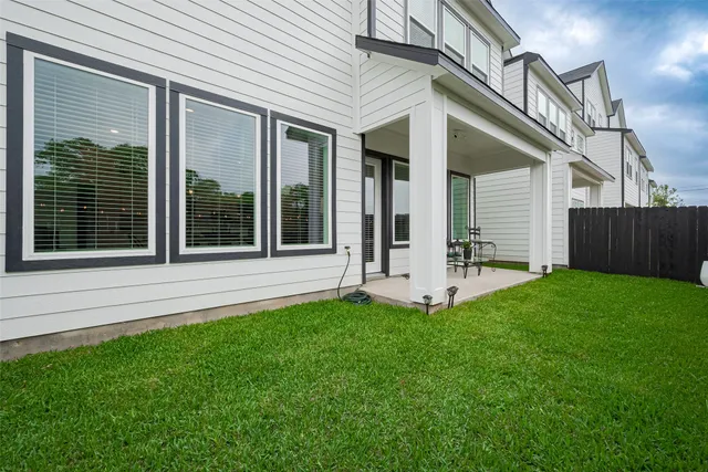 a view of a house with a yard and porch