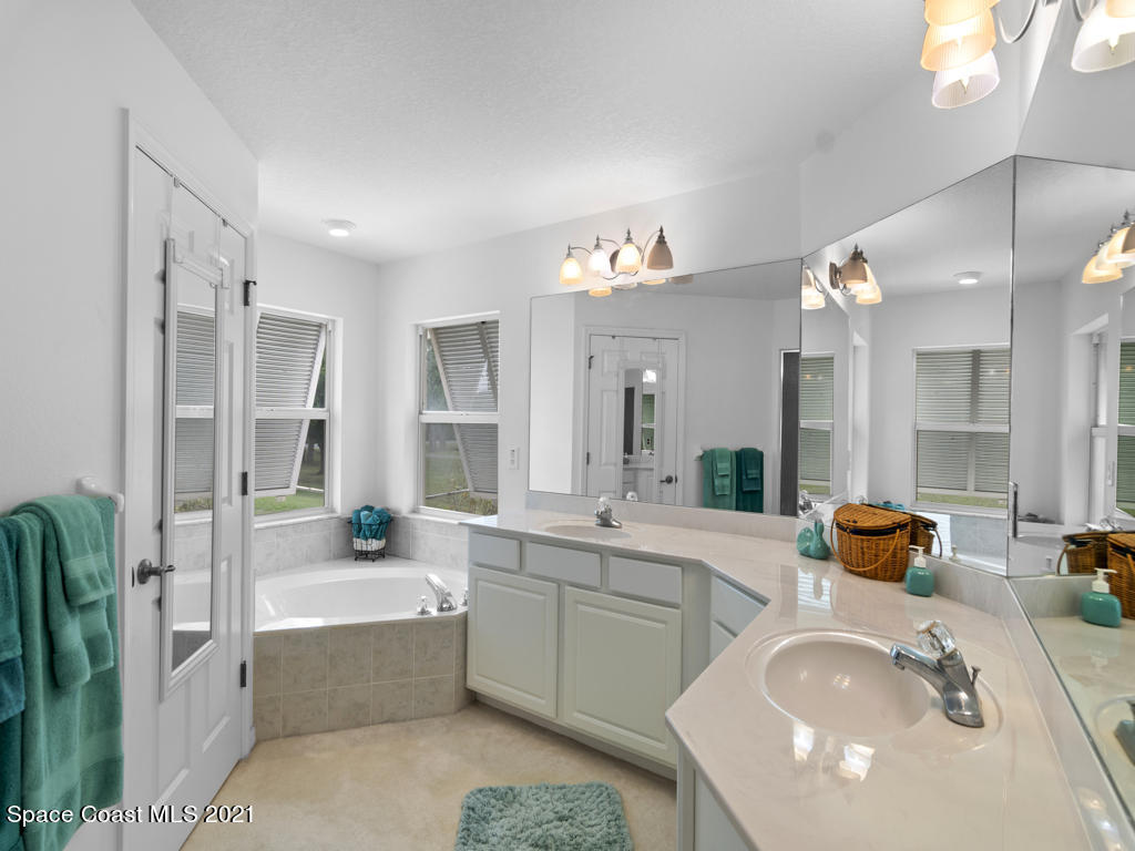 2770 Weber Road Malabar, FL 32950 - Photo 14 of 23 a bathroom with a tub sink and mirror