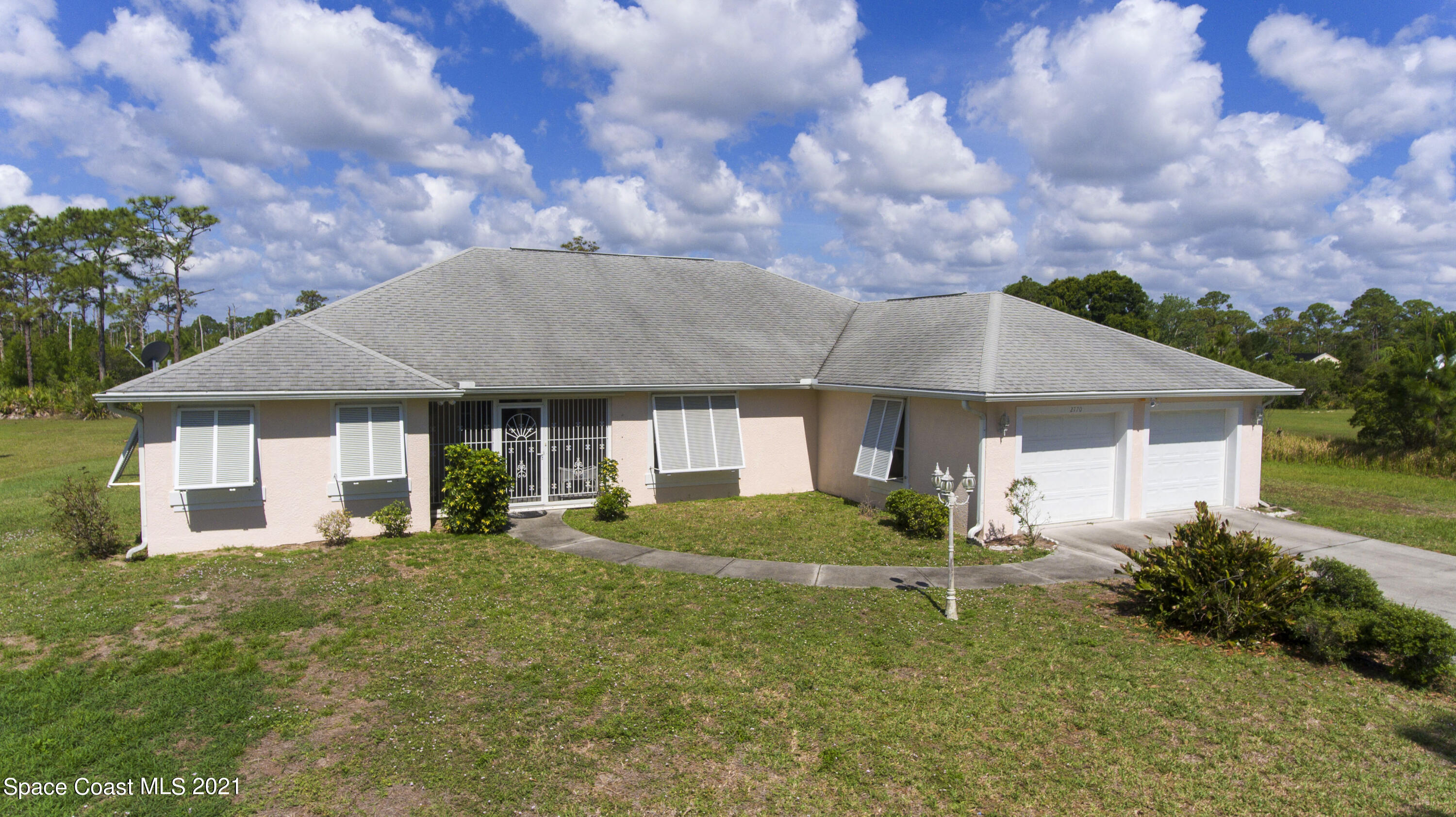 2770 Weber Road Malabar, FL 32950 - Photo 3 of 23 a front view of a house with garden