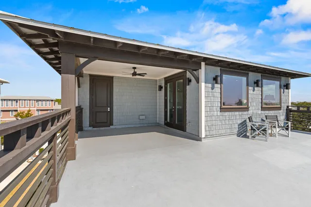 a view of swimming pool with outdoor seating and house in the background
