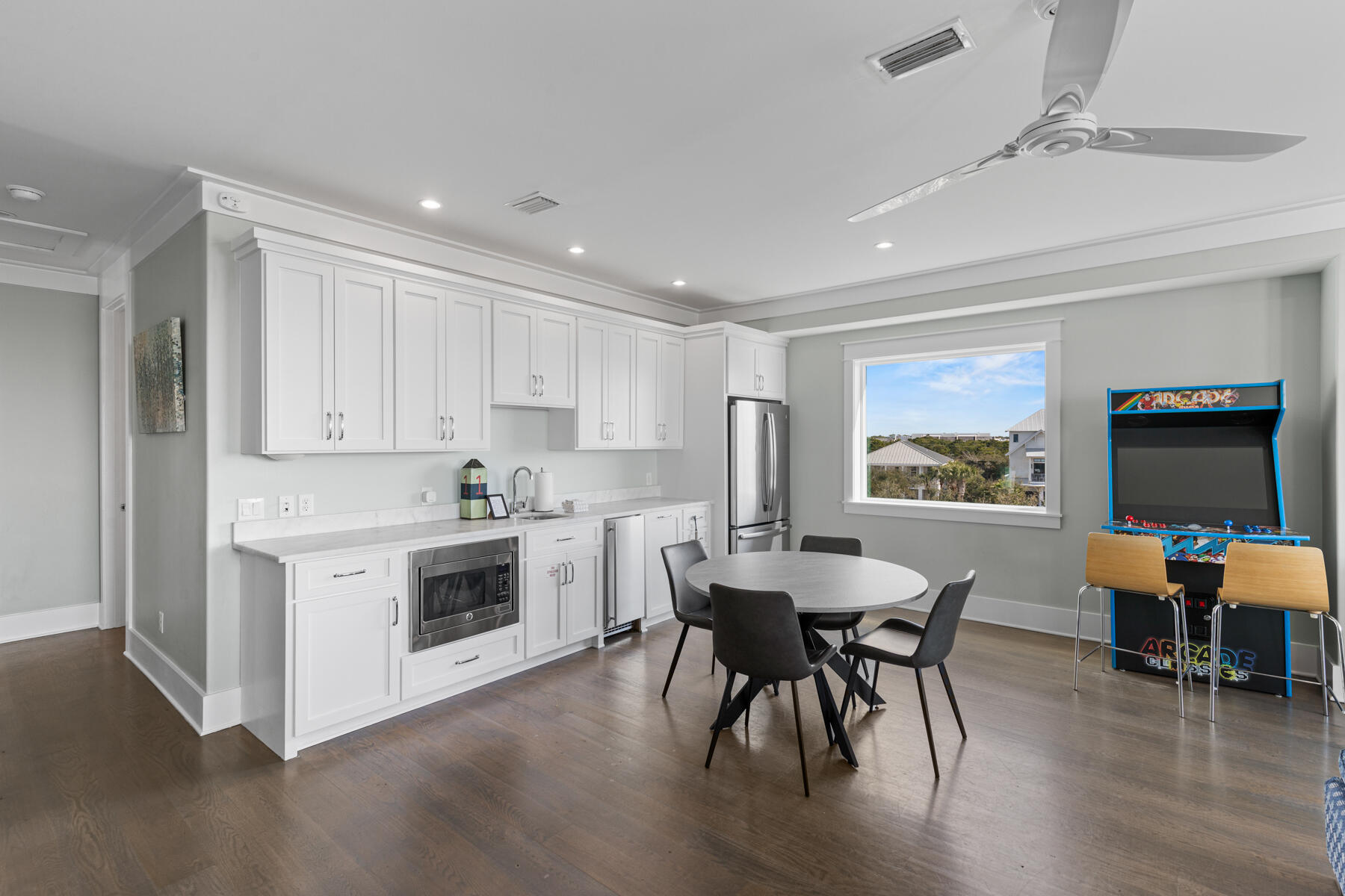 8947 East County Highway 30A Inlet Beach, FL 32461 - Photo 20 of 55 a kitchen with a table chairs stove and white cabinets