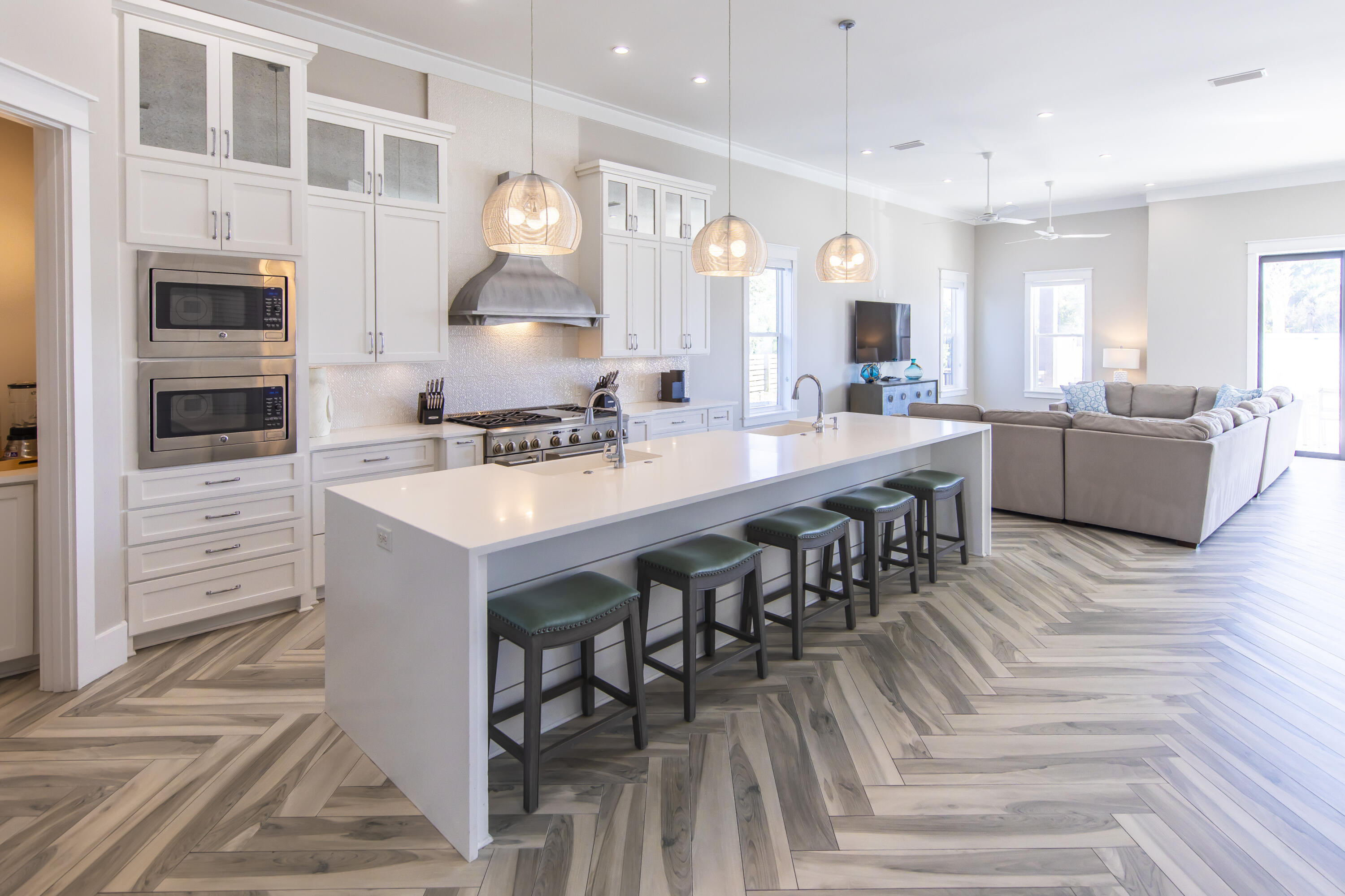8947 East County Highway 30A Inlet Beach, FL 32461 - Photo 21 of 69 a open kitchen with stainless steel appliances kitchen island granite countertop a stove a sink a dining table and chairs with wooden floor