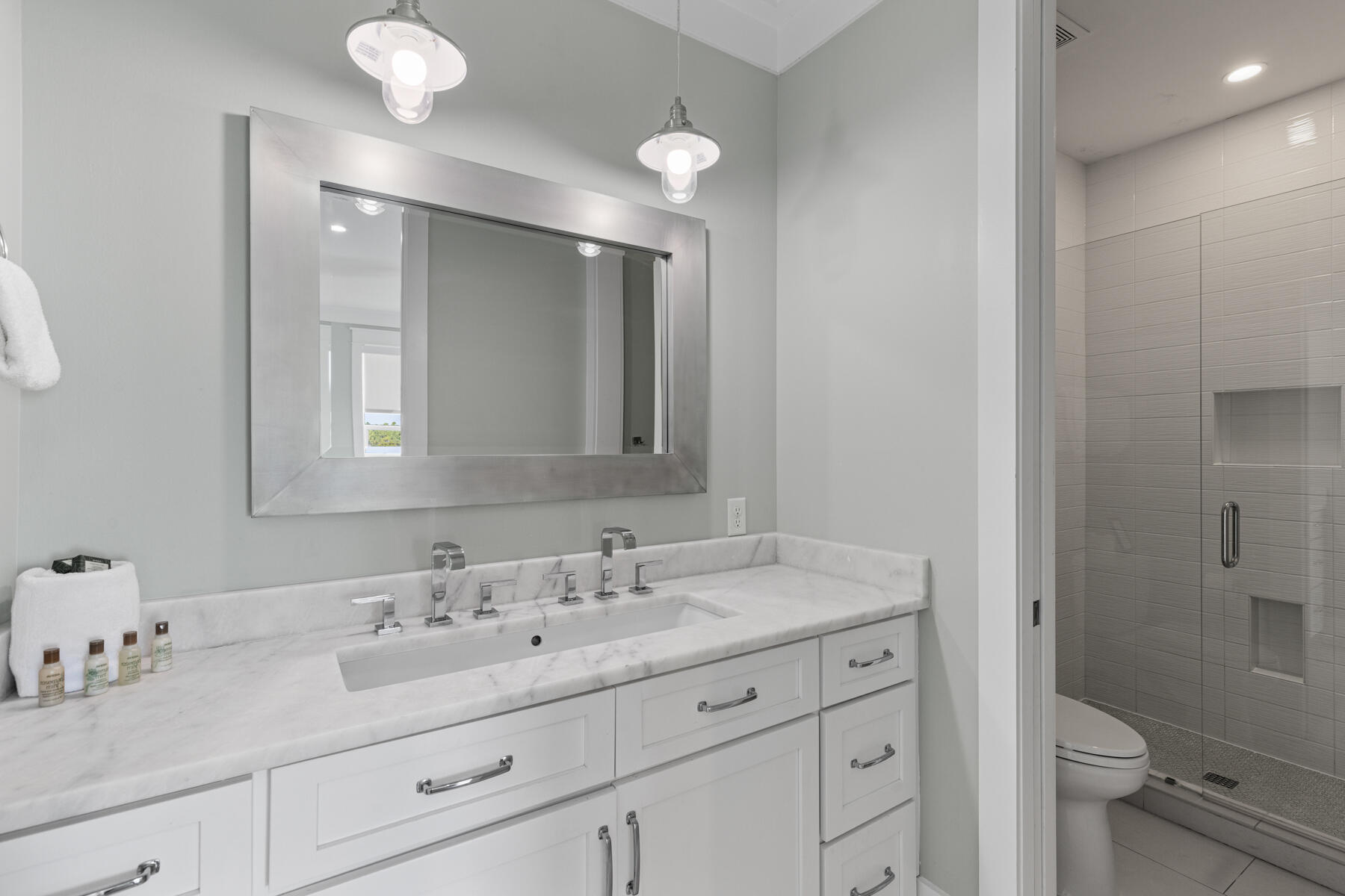 8947 East County Highway 30A Inlet Beach, FL 32461 - Photo 37 of 55 a bathroom with a sink vanity granite toilet and a mirror