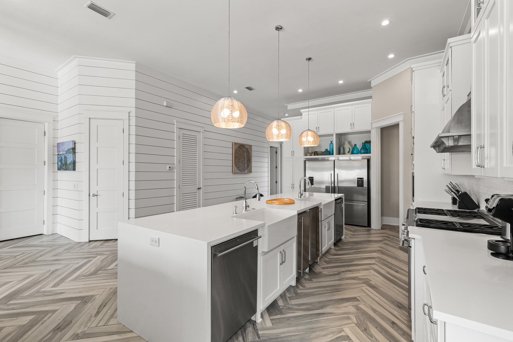 8947 East County Highway 30A Inlet Beach, FL 32461 - Photo 5 of 55 a large white kitchen with a large counter top space a sink stainless steel appliances and cabinets