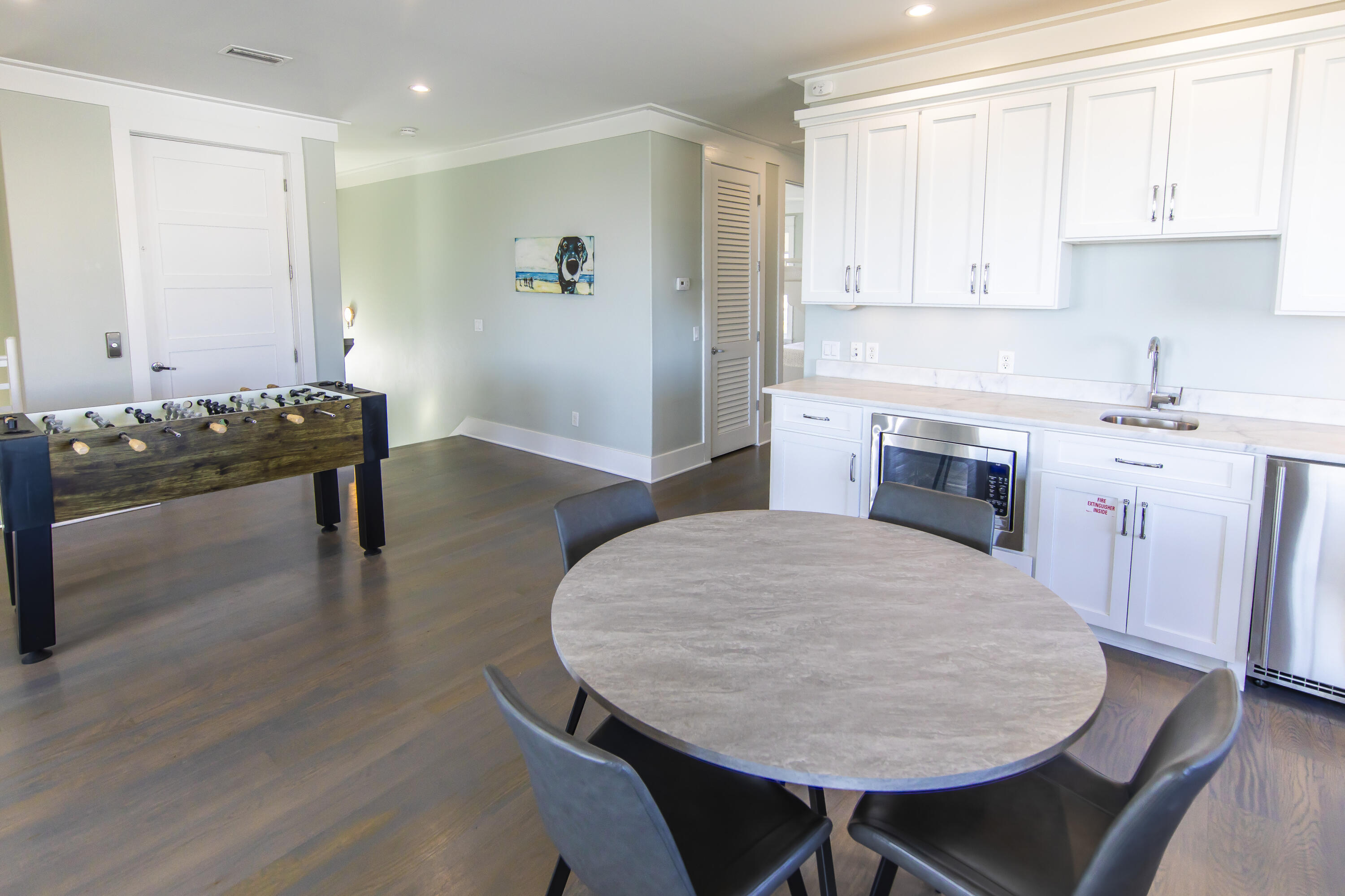 8947 East County Highway 30A Inlet Beach, FL 32461 - Photo 60 of 69 a open kitchen with dining table and wooden cabinets