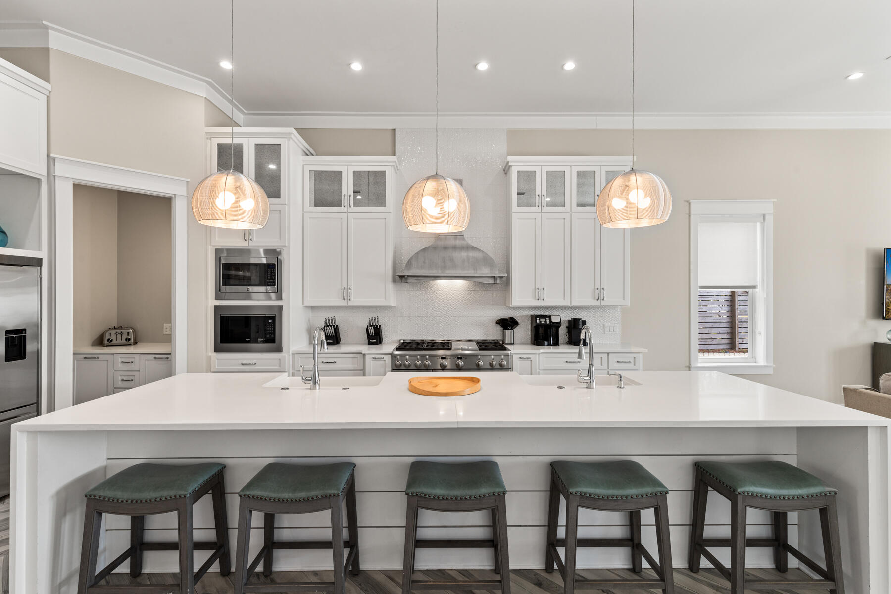 8947 East County Highway 30A Inlet Beach, FL 32461 - Photo 9 of 55 a kitchen with a dining table chairs and white cabinets