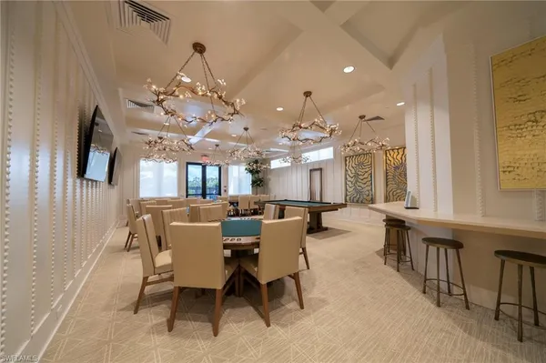 a view of a dining room with furniture and a chandelier