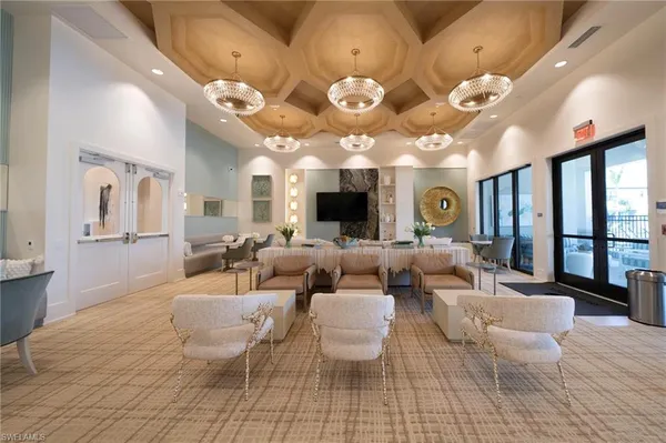 a living room with lots of furniture and view of kitchen