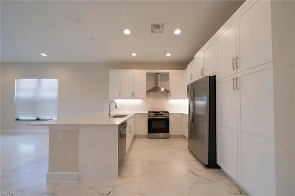 a view of a kitchen with a sink and a stove top oven