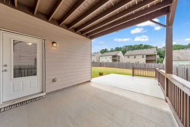 a view of a house with a yard and large tree