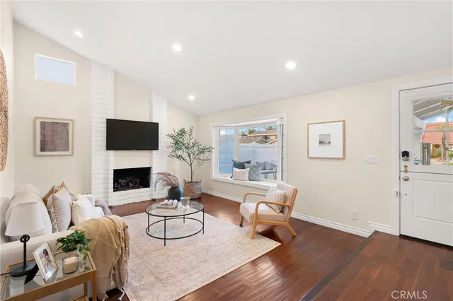 a living room with furniture a fireplace and a flat screen tv